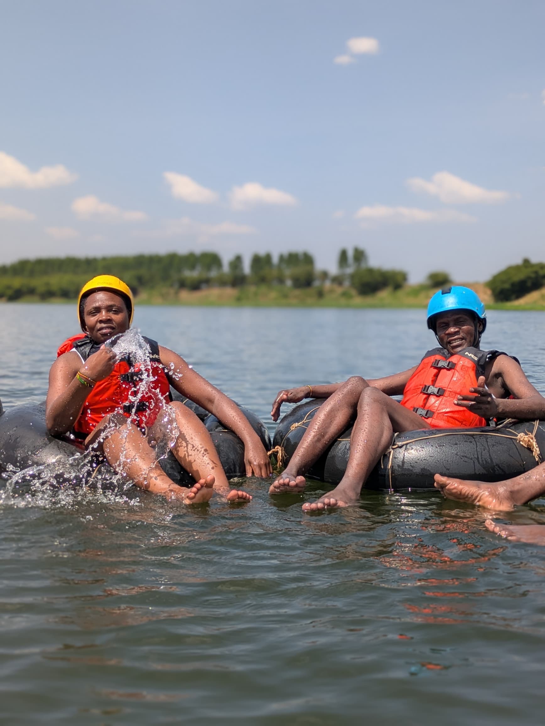 Two tubers kicking water at each other