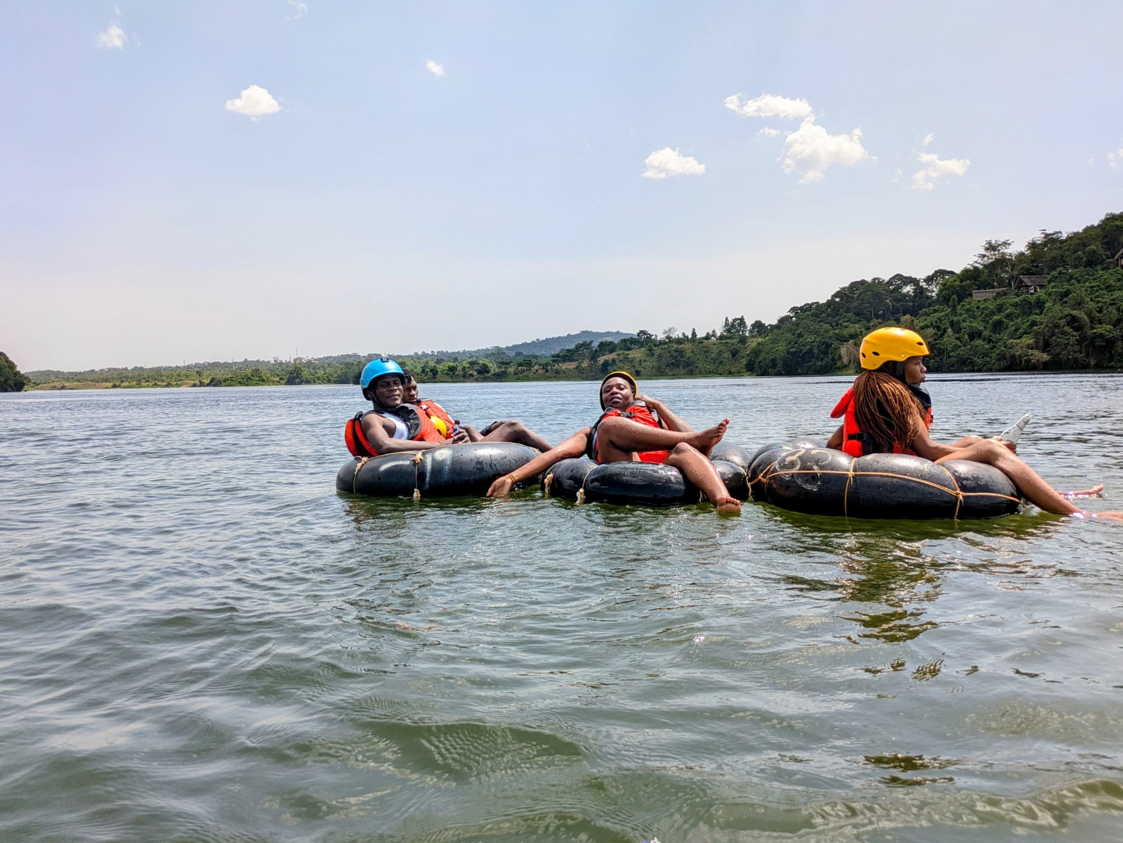 Three tubers on the Nile with green hills behind